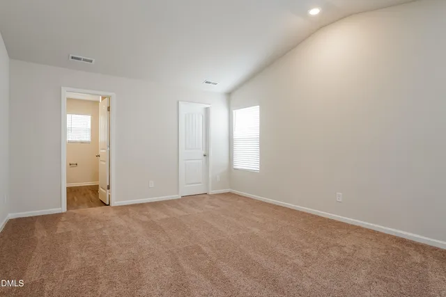 an empty room with windows and closet