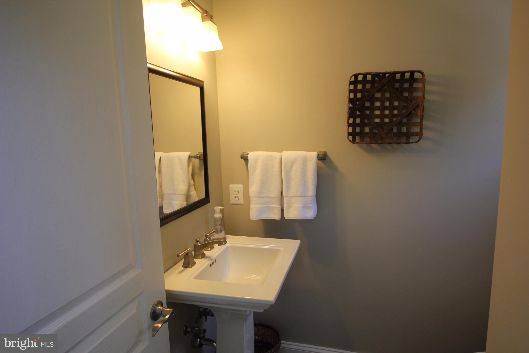 6095 Hanover Road Hanover, MD 21076 - Photo 11 of 30 a bathroom with a sink and a mirror