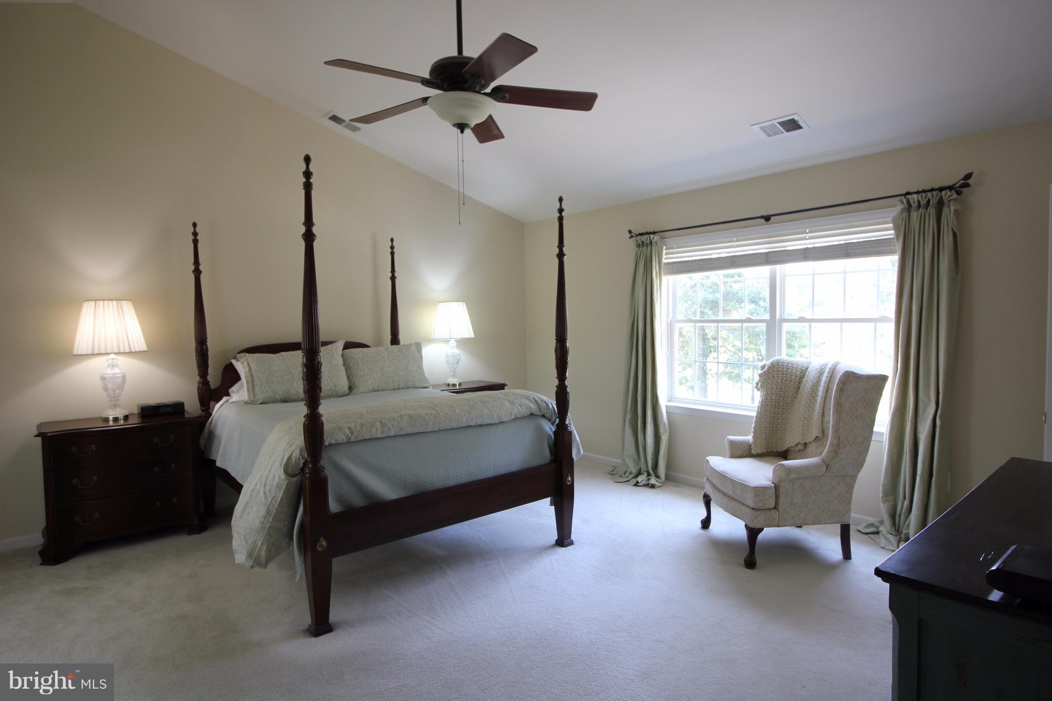 6095 Hanover Road Hanover, MD 21076 - Photo 13 of 30 a bedroom with a bed chairs and fan in it
