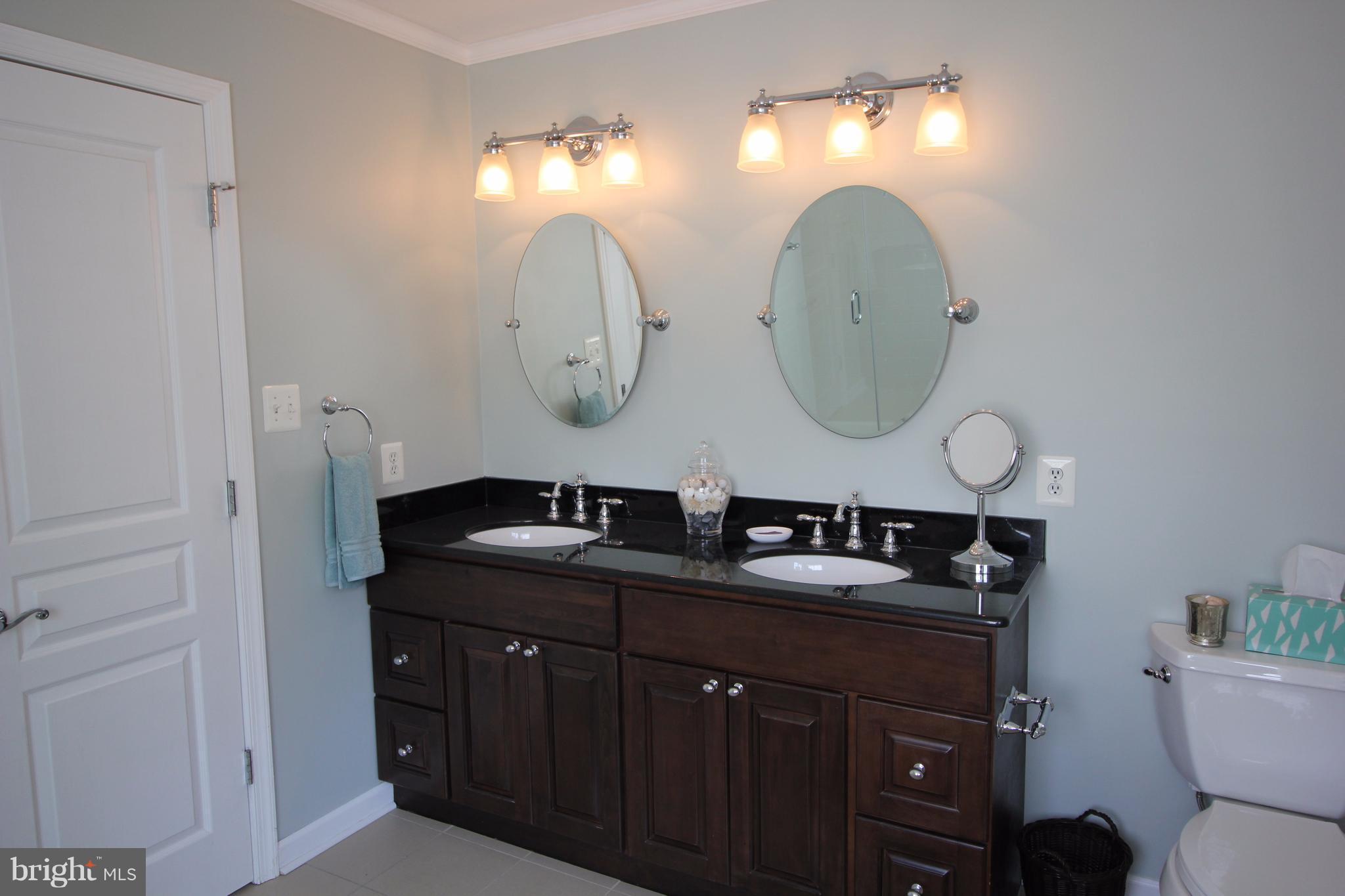 6095 Hanover Road Hanover, MD 21076 - Photo 15 of 30 a bathroom with a double vanity sink and a mirror