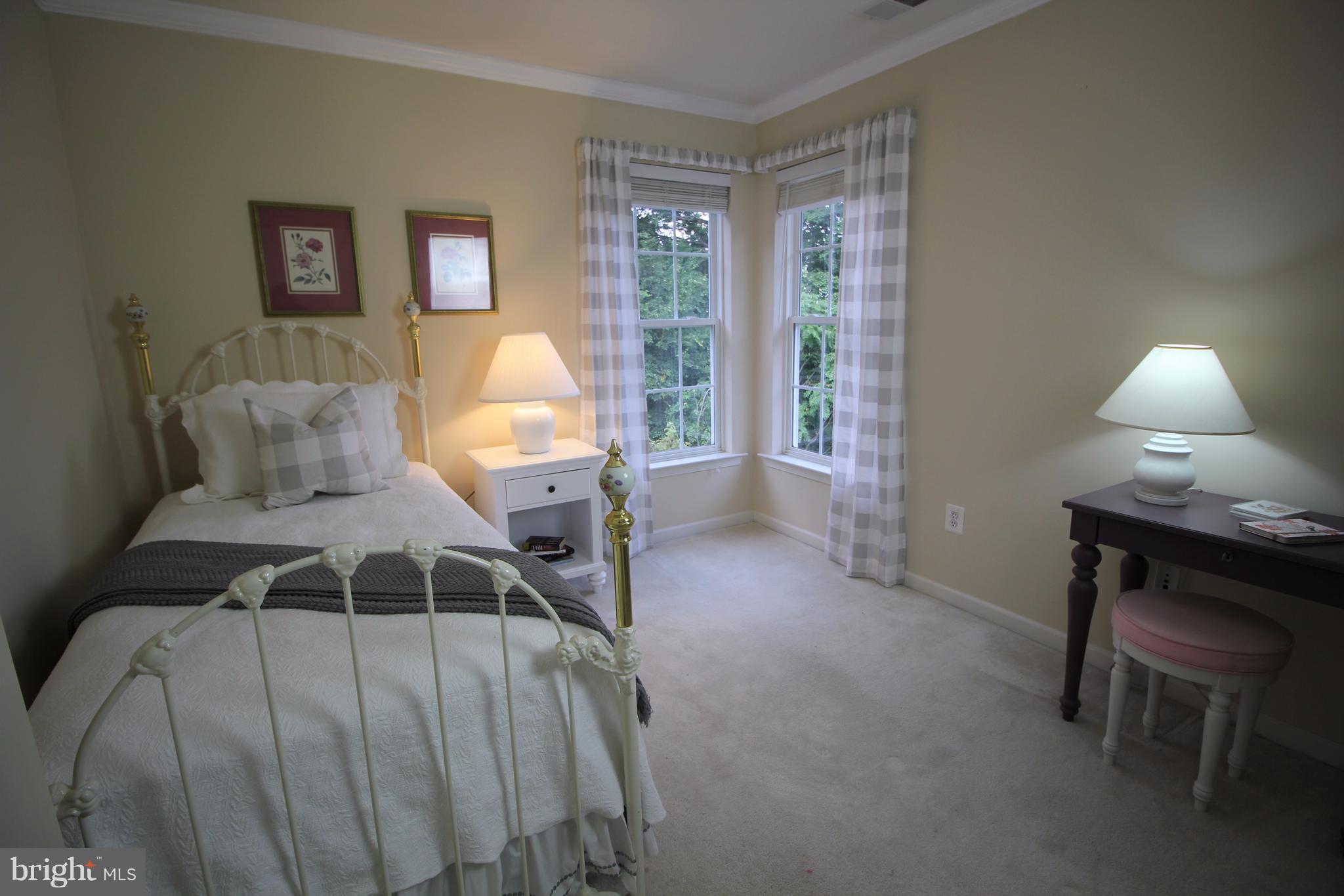 6095 Hanover Road Hanover, MD 21076 - Photo 19 of 30 a bedroom with a bed a table and chair