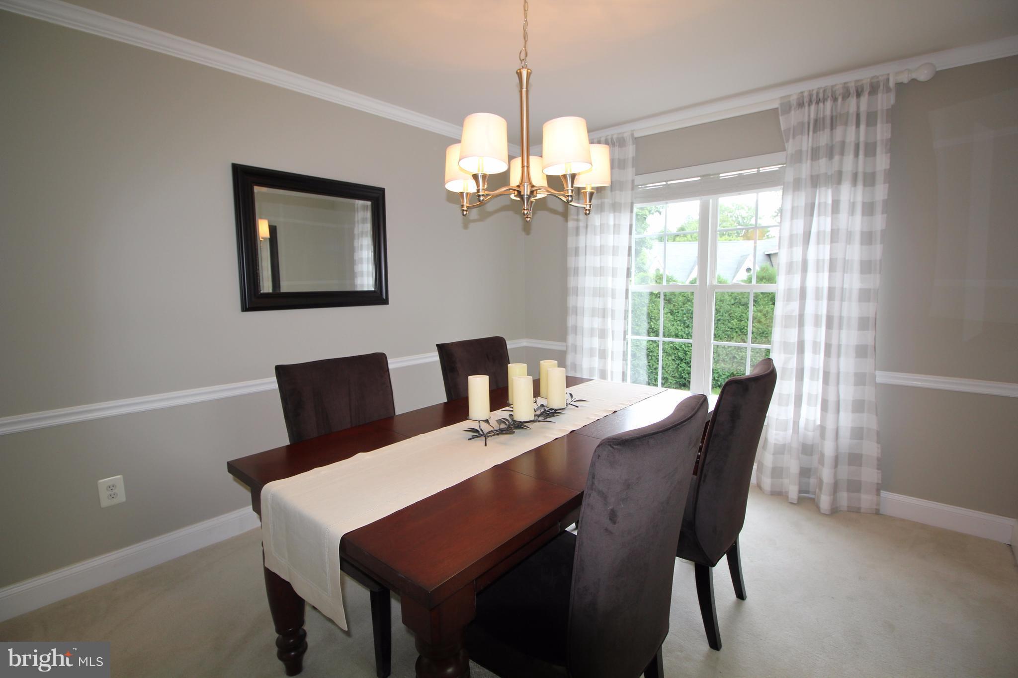 6095 Hanover Road Hanover, MD 21076 - Photo 5 of 30 a view of a dining room with furniture a chandelier and a window