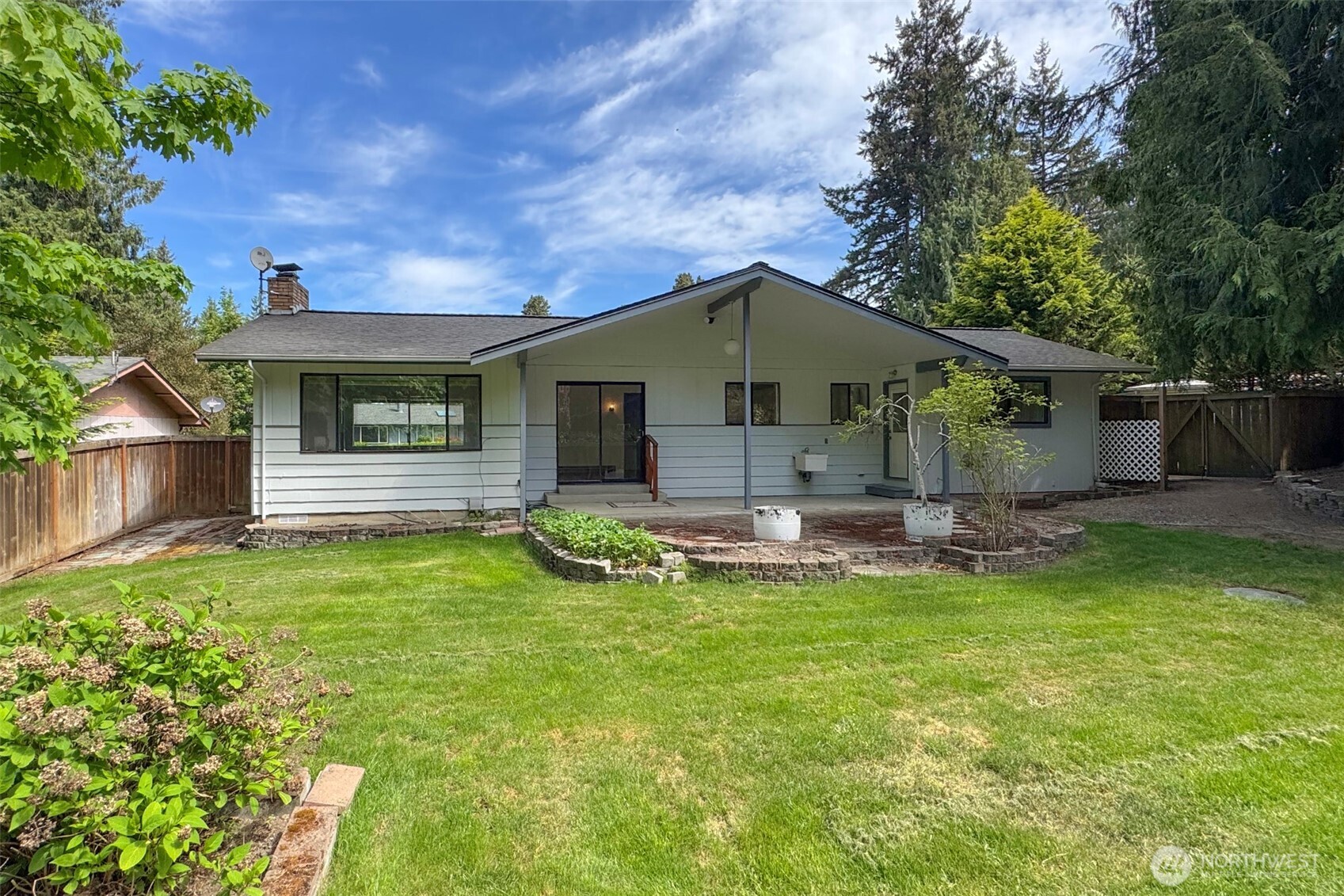 370 Dungeness Meadows Sequim, WA 98382 - Photo 11 of 40 a front view of a house with swimming pool having outdoor seating