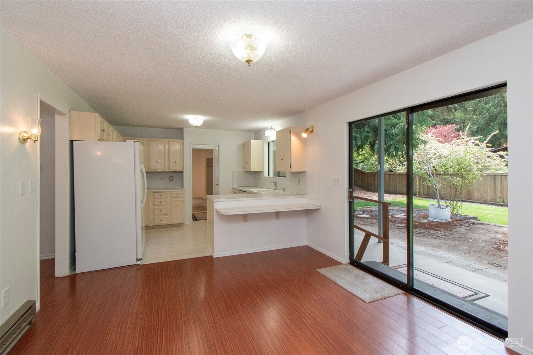 370 Dungeness Meadows Sequim, WA 98382 - Photo 13 of 40 a view of a kitchen with wooden floor and a refrigerator