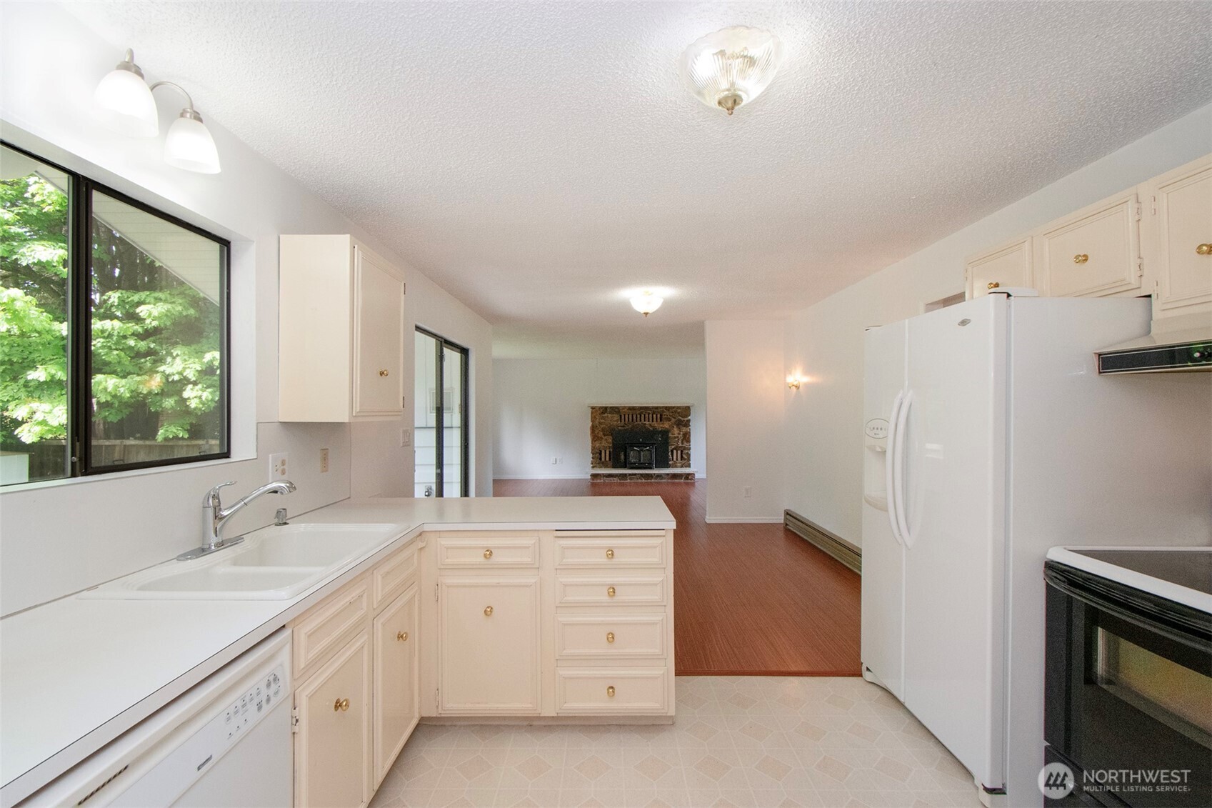 370 Dungeness Meadows Sequim, WA 98382 - Photo 16 of 40 a large white kitchen with a sink stainless steel appliances and cabinets