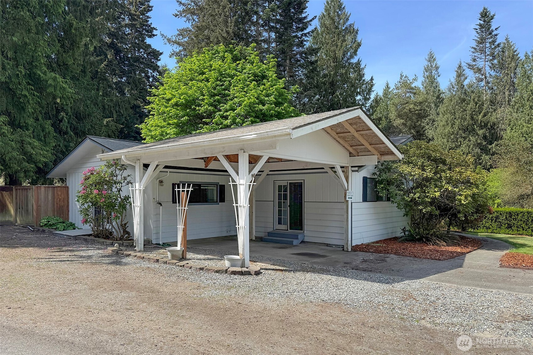 370 Dungeness Meadows Sequim, WA 98382 - Photo 2 of 40 a view of a white house with a small yard and large trees