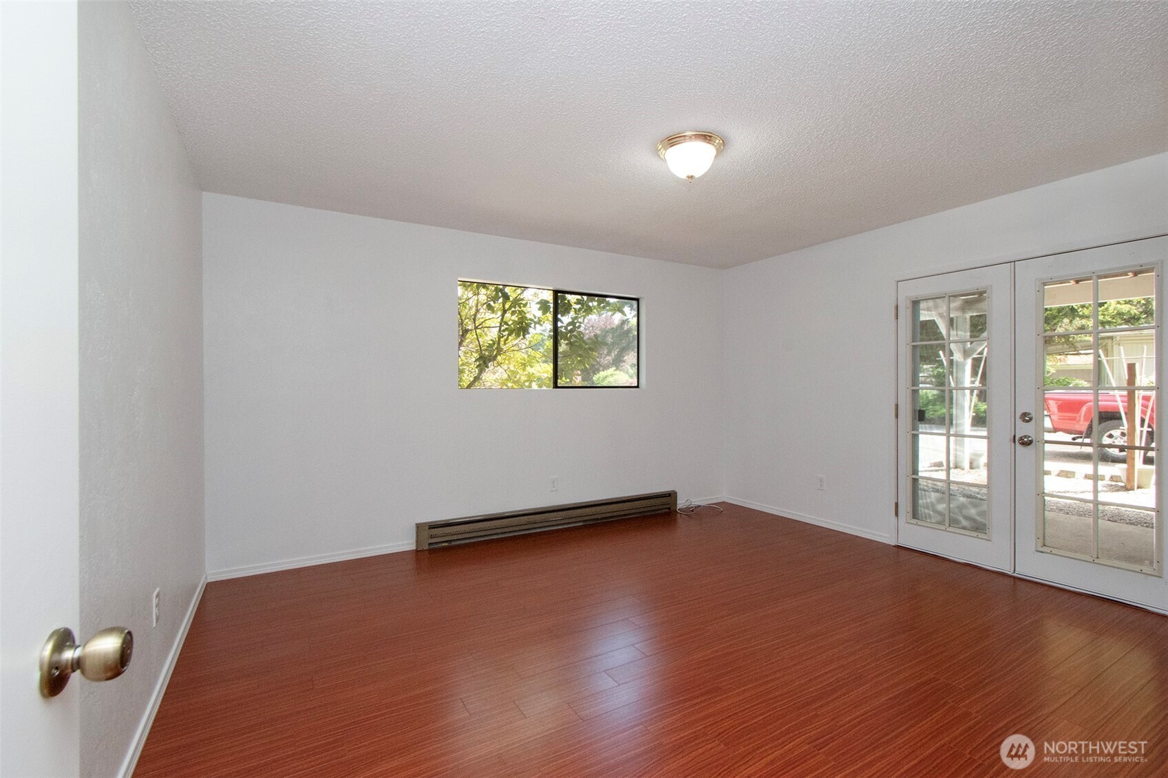 370 Dungeness Meadows Sequim, WA 98382 - Photo 23 of 40 an empty room with wooden floor and windows