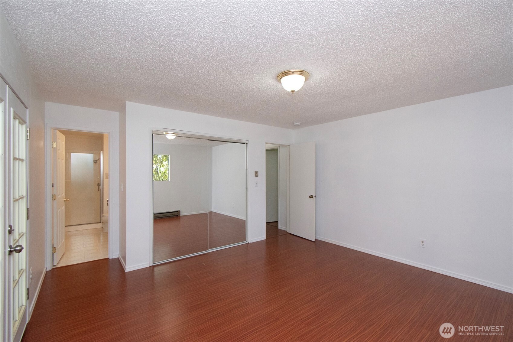 370 Dungeness Meadows Sequim, WA 98382 - Photo 25 of 40 an empty room with wooden floor & mirror