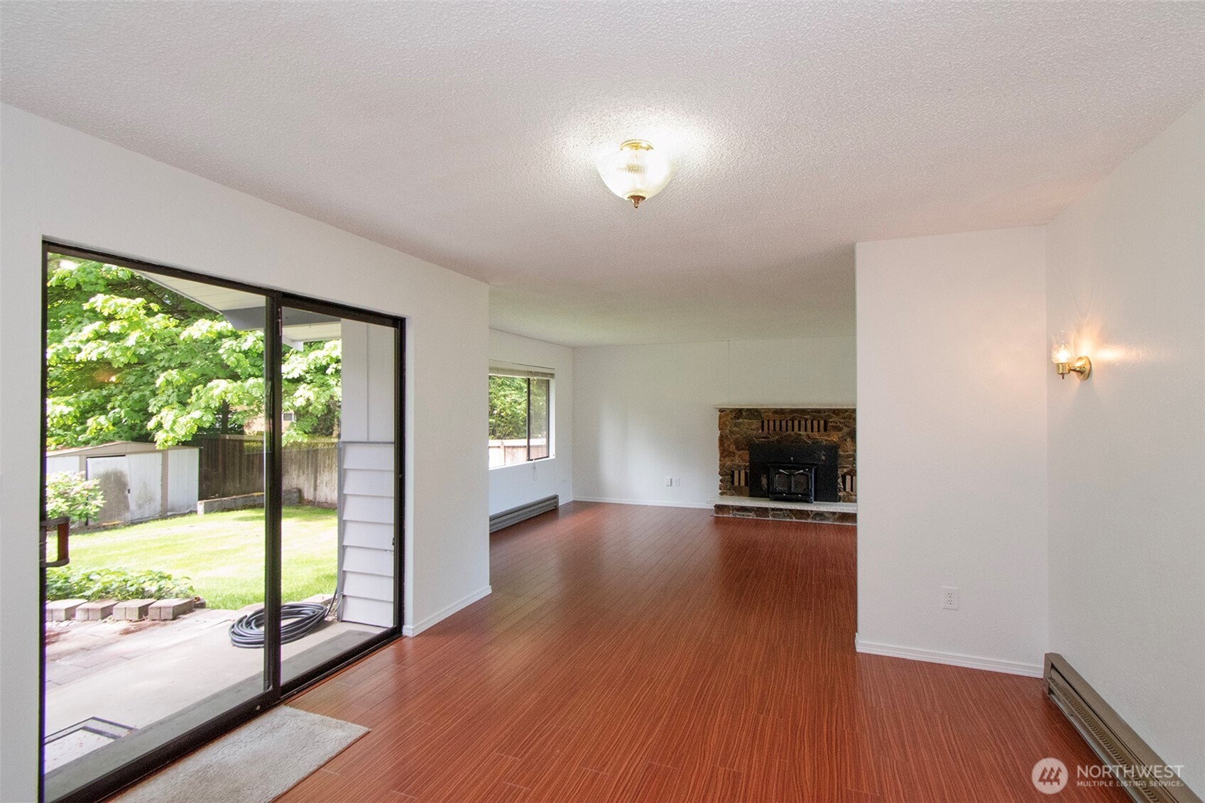 370 Dungeness Meadows Sequim, WA 98382 - Photo 9 of 40 a view of an empty room with wooden floor and a window