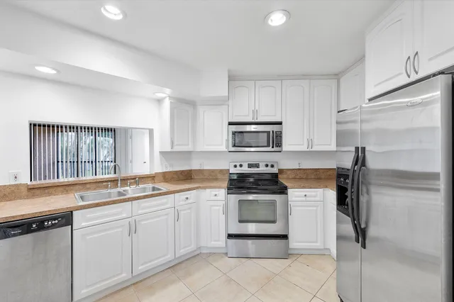 a kitchen with a sink appliances and cabinets