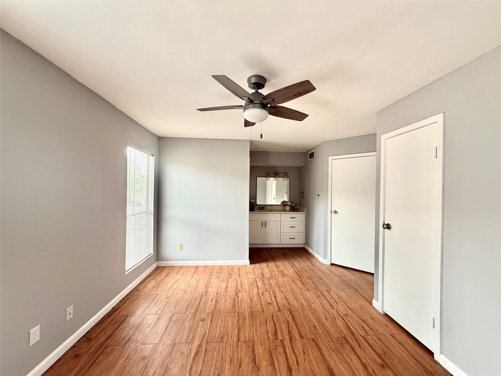 7200 West T C Jester Boulevard, Unit 3902 North Houston, TX 77088 - Photo 11 of 16 a view of a room with a ceiling fan wooden floor and a ceiling fan