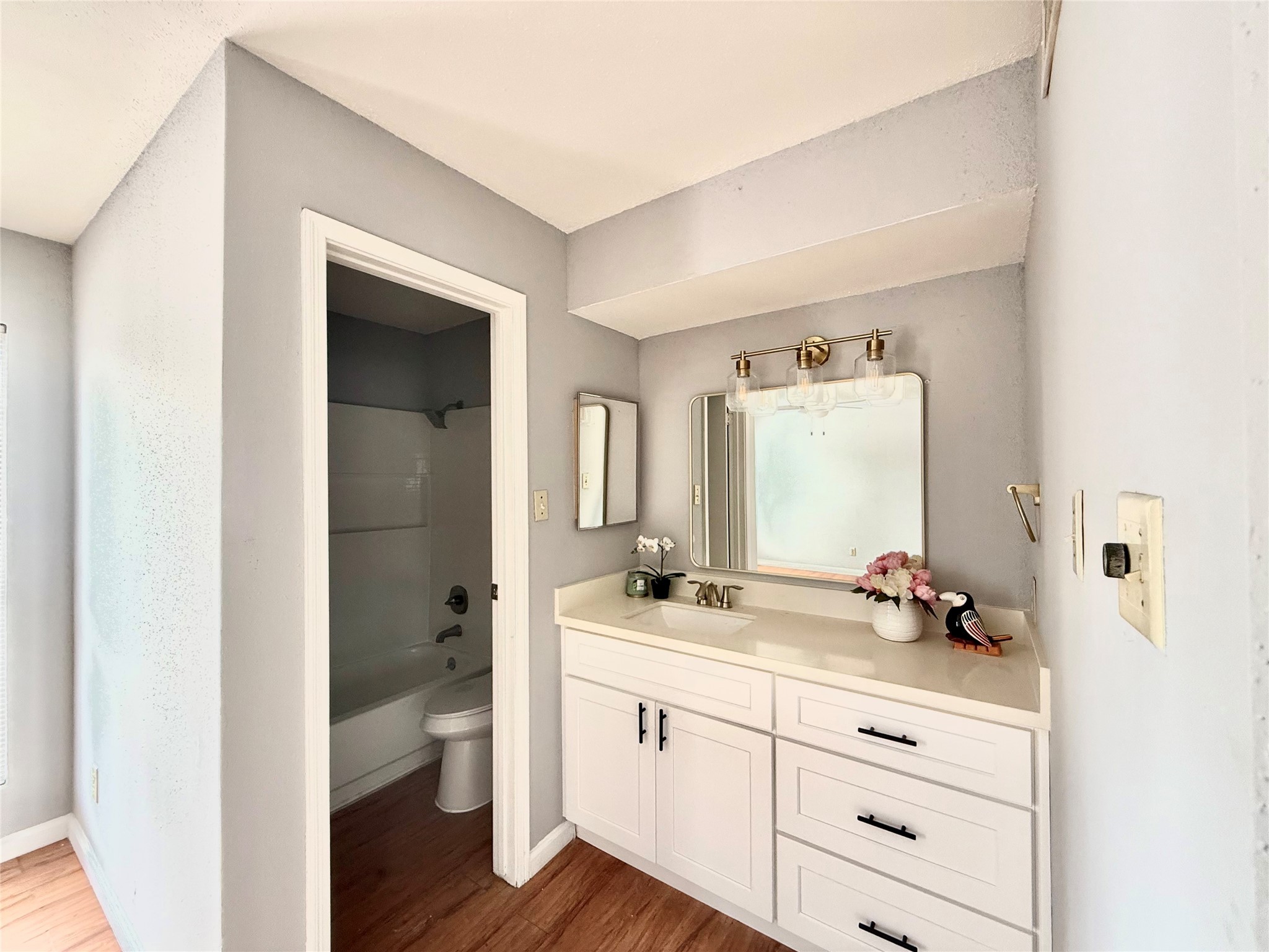 7200 West T C Jester Boulevard, Unit 3902 North Houston, TX 77088 - Photo 12 of 16 a bathroom with a sink a toilet and a mirror