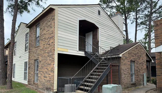 a view of a house with iron stairs