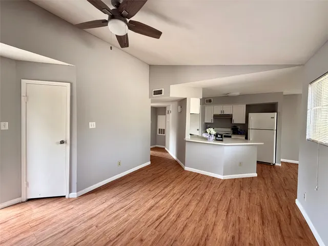 a view of kitchen with refrigerator microwave and stove