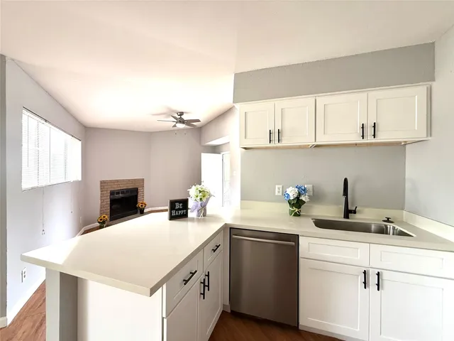 a kitchen with a sink cabinets and window