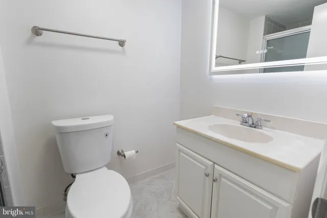 a white toilet sitting next to a bathroom sink