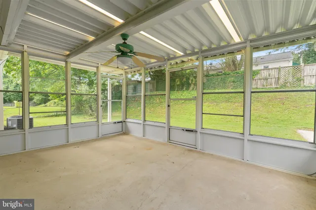 a view of an empty room with windows