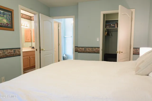 a bedroom with a bed and a cabinets