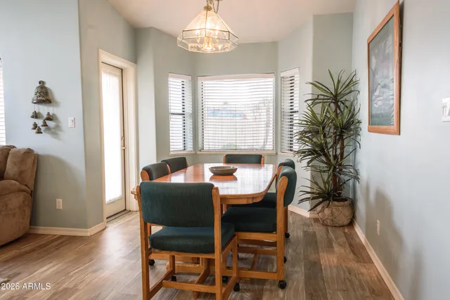 a view of a dining room with furniture window and wooden floor