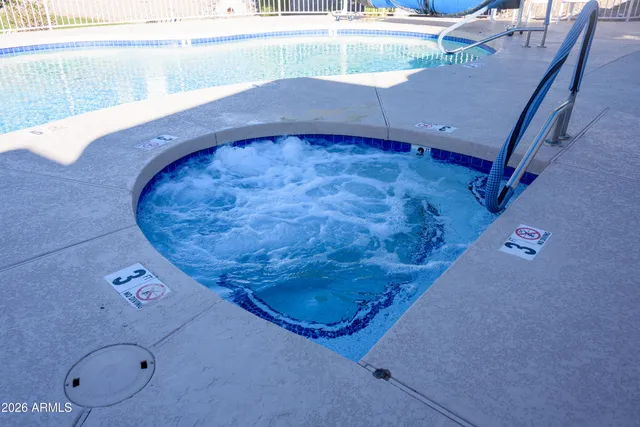 a view of a swimming pool with an outdoor seating