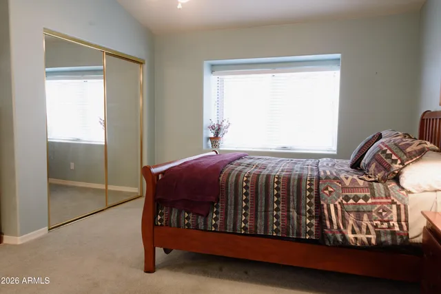 a bedroom with a bed and window