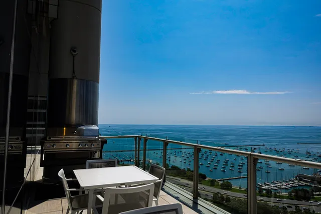 a balcony with a table and chairs