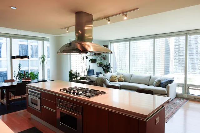 a large kitchen with a stove and a large window