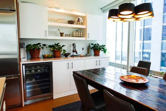 a kitchen with a table chairs stove and cabinets