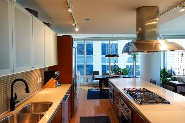 a kitchen with lots of counter top space and stainless steel appliances