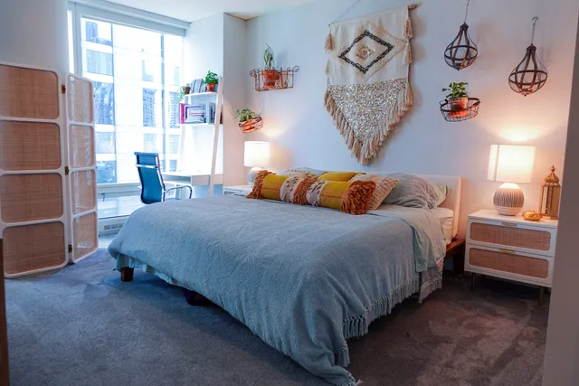 a bedroom with a bed and a window