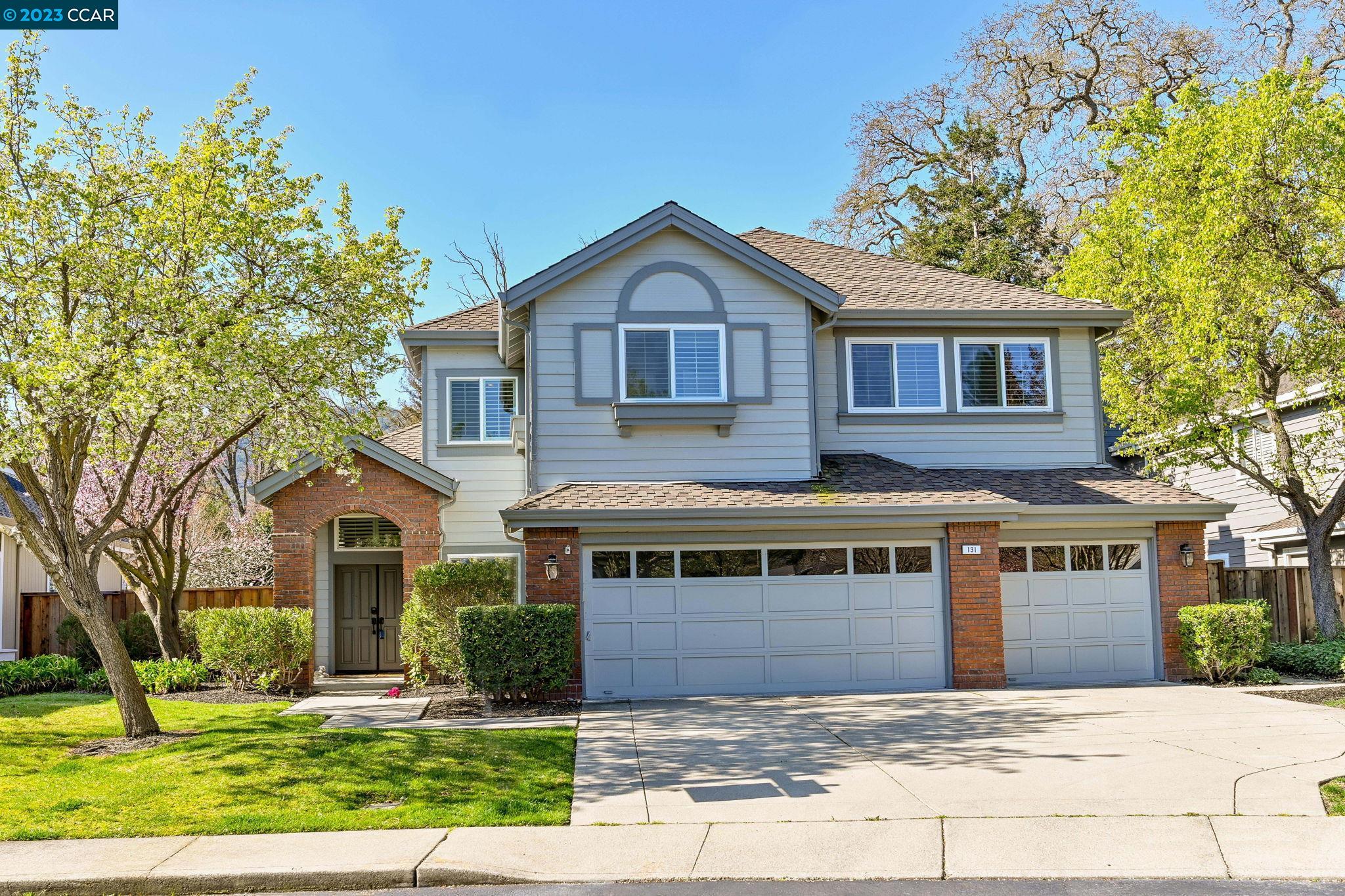 a front view of a house with a yard and garage