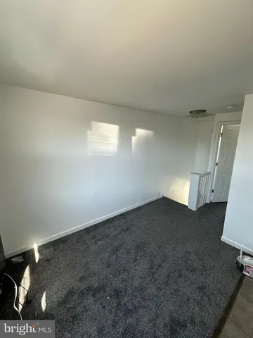 a view of an empty room and a fireplace