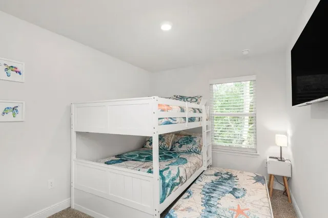 a bedroom with furniture and a window