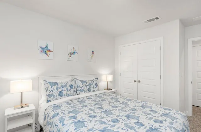 a bedroom with a bed and a lamp