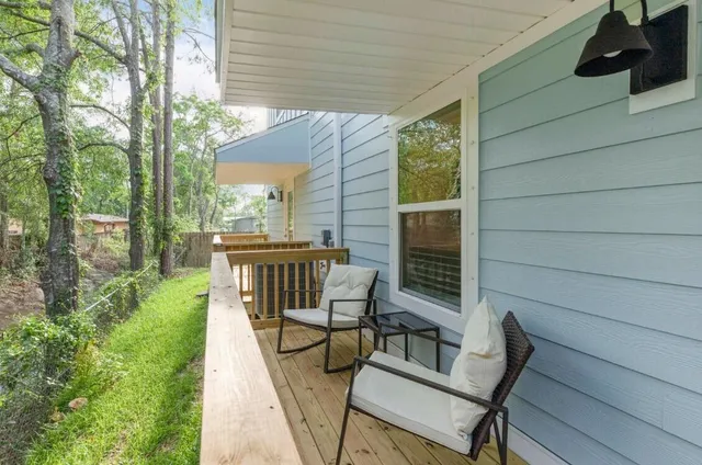 a view of a chair and tables in the balcony