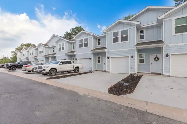 a car parked in front of a white house
