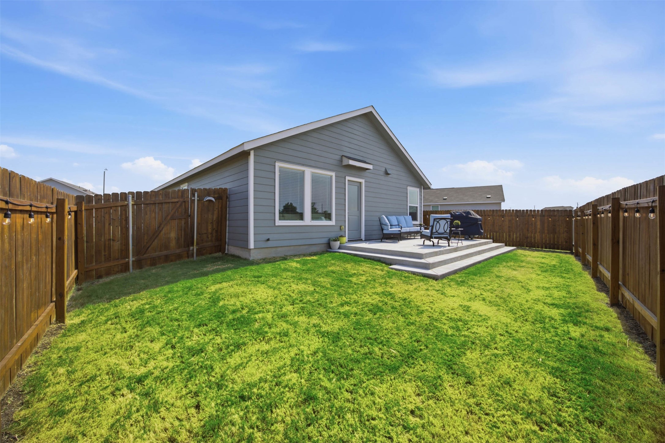 171 Cattle Queen Road Jarrell, TX 76537 - Photo 30 of 38 A spacious backyard features a level lawn enclosed by a wooden privacy fence.