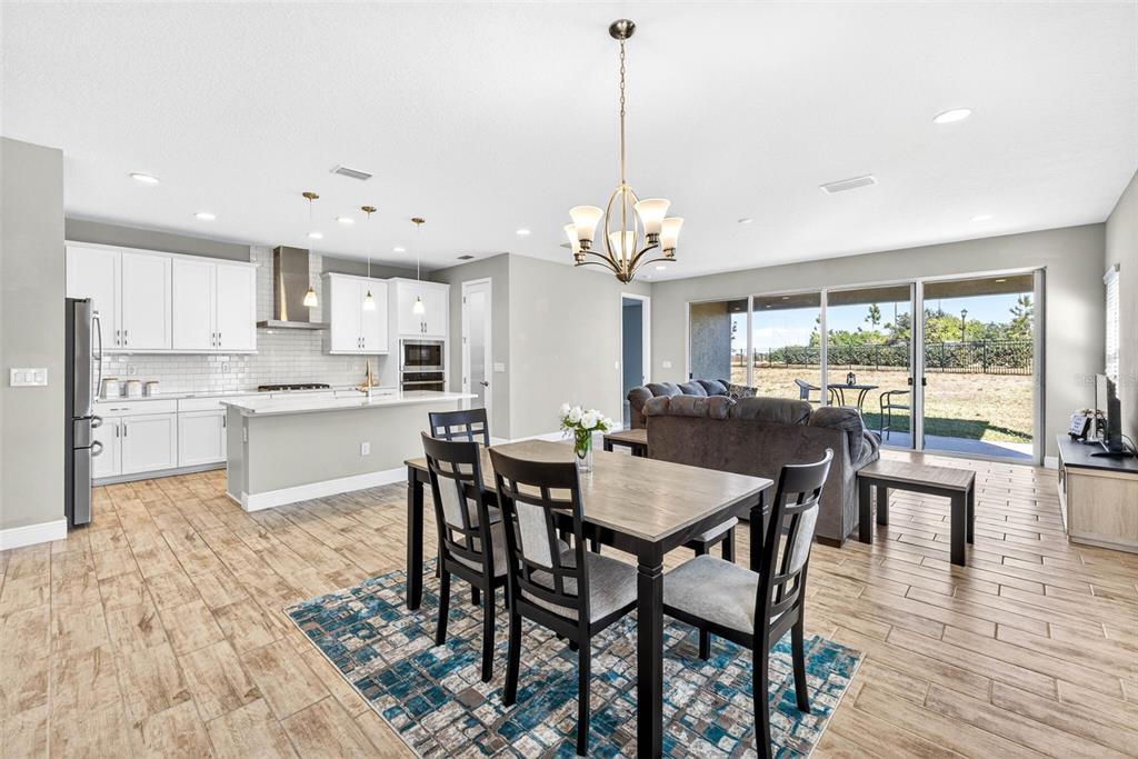 6394 Roadstead Court Apollo Beach, FL 33572 - Photo 14 of 49 a view of a dining room and livingroom with furniture wooden floor a chandelier