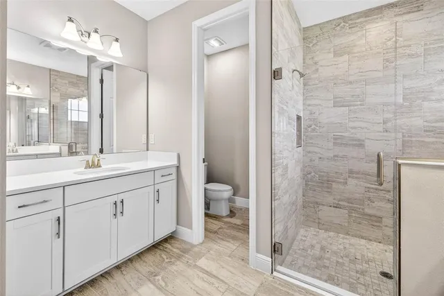 a bathroom with a double vanity sink and mirror