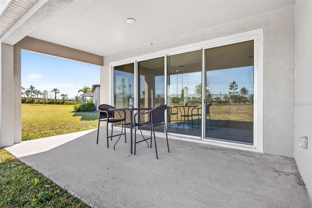6394 Roadstead Court Apollo Beach, FL 33572 - Photo 32 of 49 a dining room with furniture and floor to ceiling window