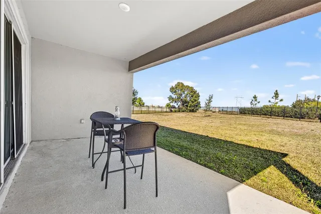 a view of a house with backyard and sitting area