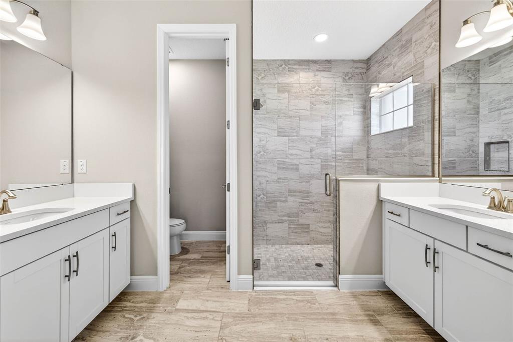 6394 Roadstead Court Apollo Beach, FL 33572 - Photo 4 of 49 a bathroom with a granite countertop sink toilet and shower