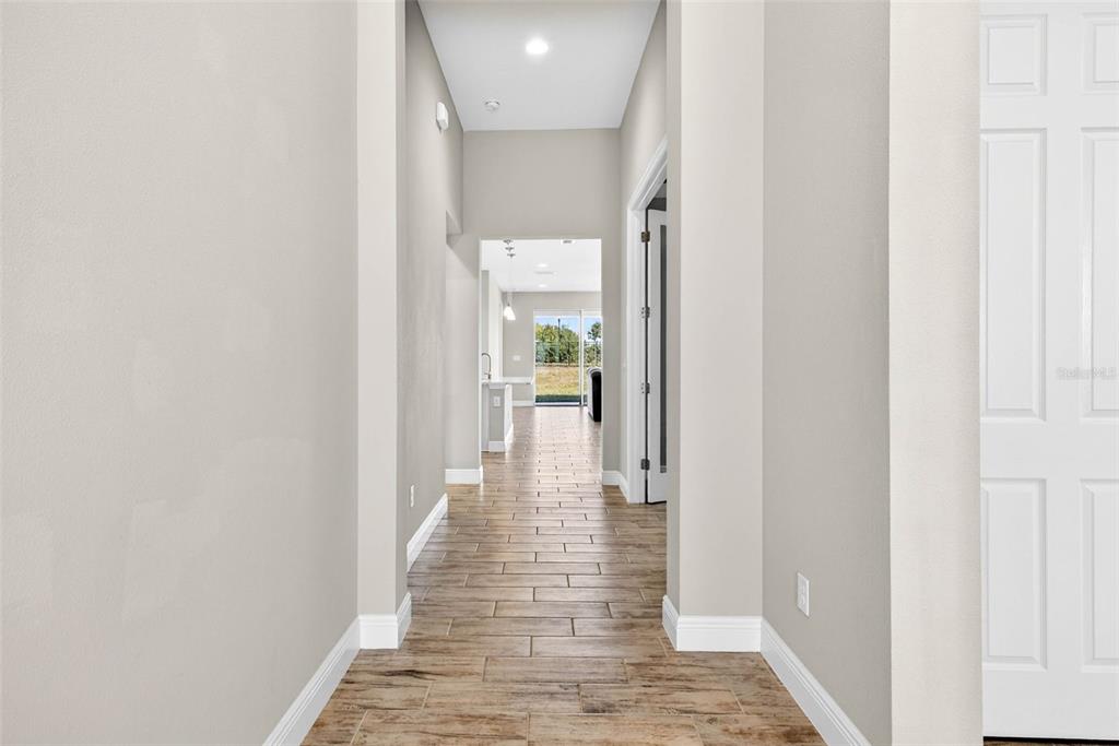 6394 Roadstead Court Apollo Beach, FL 33572 - Photo 7 of 49 a view of a hallway with wooden floor and a bathroom