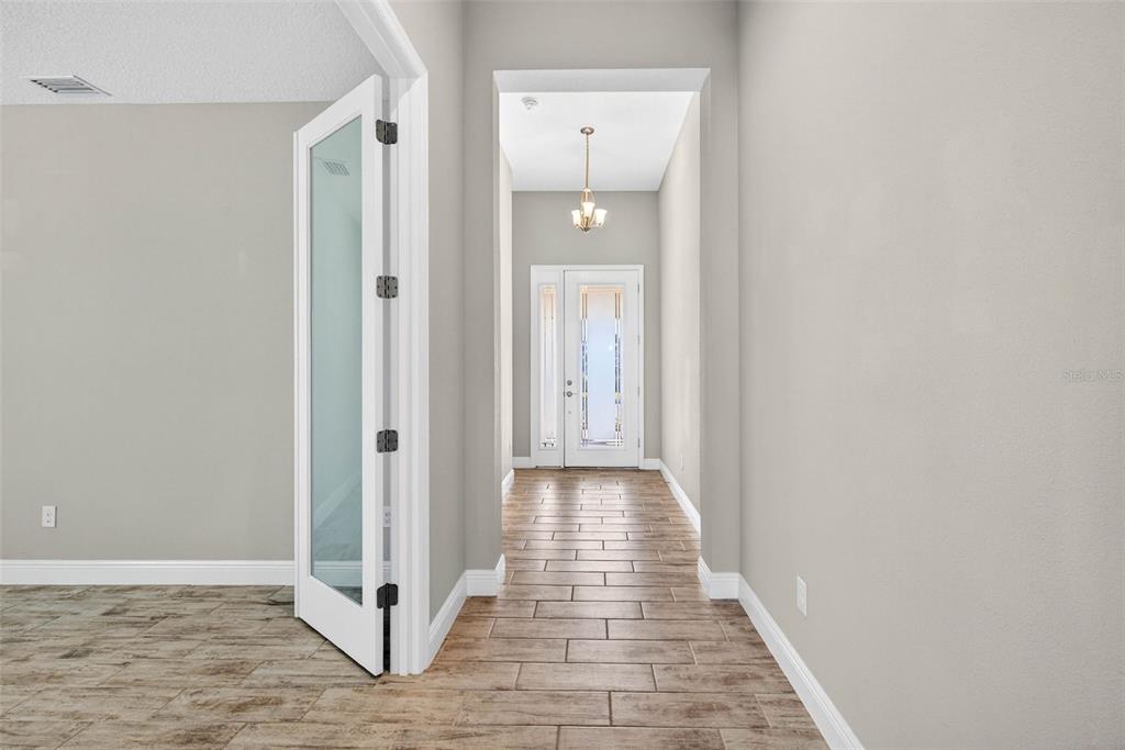 6394 Roadstead Court Apollo Beach, FL 33572 - Photo 8 of 49 a view of a hallway with wooden floor