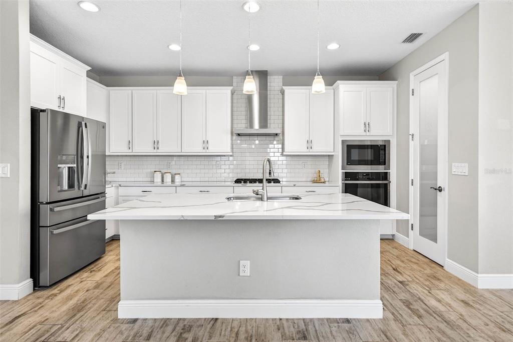 6394 Roadstead Court Apollo Beach, FL 33572 - Photo 10 of 49 a kitchen with kitchen island stainless steel appliances a sink and counter space