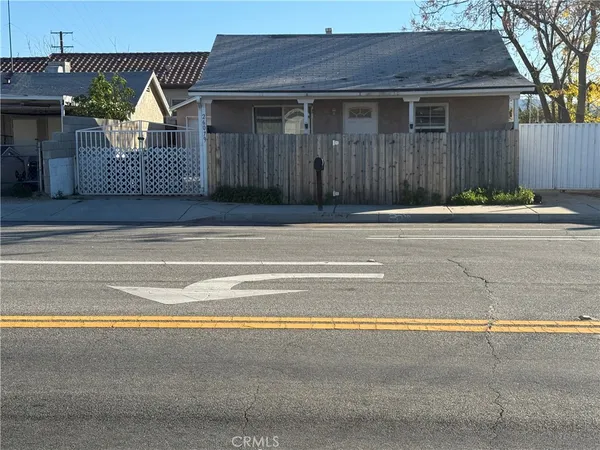 a view of a house with a small backyard