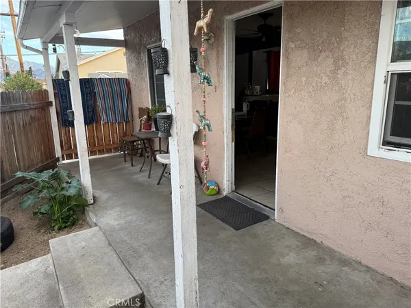 a view of a porch with wooden floor and a yard