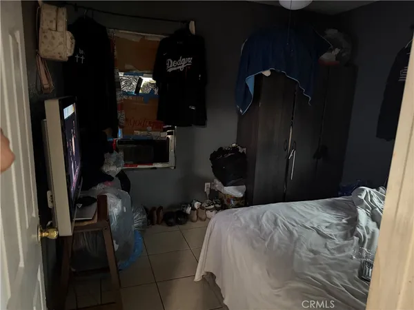 a bed room with a bed and a television