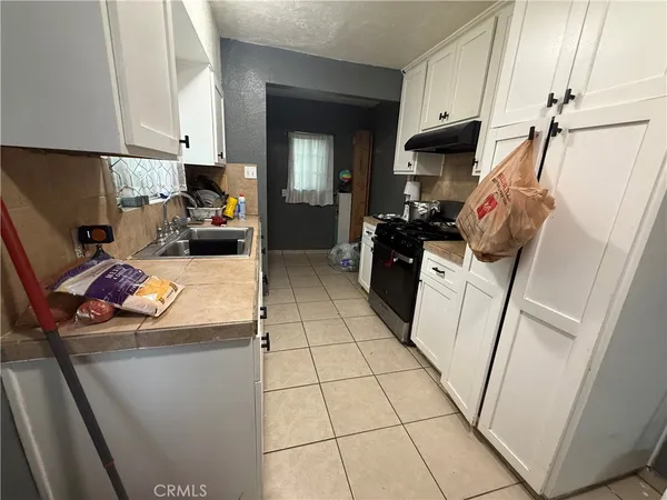 a kitchen with sink refrigerator and stove