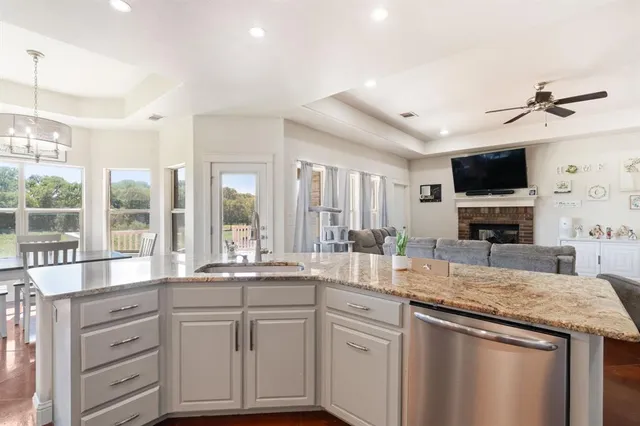 a kitchen with granite countertop a sink and a stove